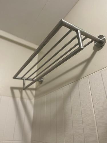 a metal towel rack hanging from a wall at Two Bedroom with Balcony 70sqm -Pasig in Manila