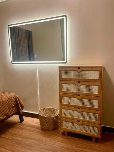 a bedroom with a dresser and a mirror at Two Bedroom with Balcony 70sqm -Pasig in Manila