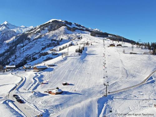 a snow covered ski slope with a ski lift at Apartment Emma-9 by Interhome in Dürnberg