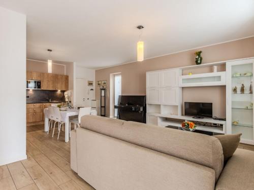 a living room with a couch and a kitchen at Apartment Il Melo-1 by Interhome in Garzeno