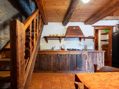 a kitchen with a wooden staircase and a stove at Apartment Baita del Celtico 2 by Interhome in Advise
