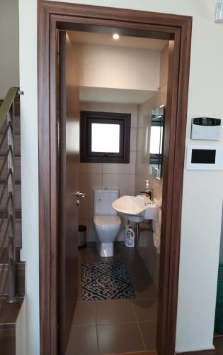 a bathroom with a toilet and a sink at Marios Villa in Larnaka
