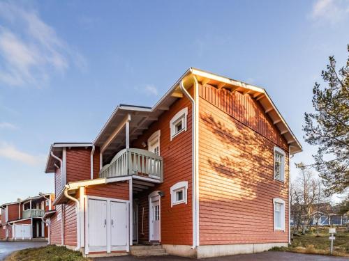 a red house with a white garage at Holiday Home Rautulampi g14 by Interhome in Saariselka