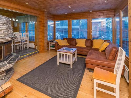 a living room with a couch and a fireplace at Holiday Home Alakoski by Interhome in Ivalo