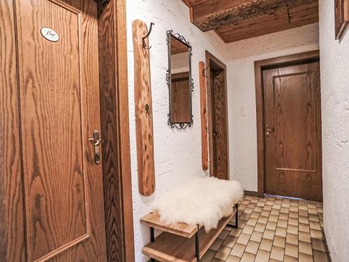 an empty room with a door and a bench at Apartment Ferienwohnung Gartenblick by Interhome in Öblarn