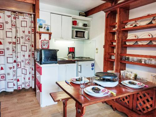 une cuisine avec une table en bois et des plaques de cuisson. dans l'établissement Studio La Piste-5 by Interhome, à Saint-Gervais-les-Bains