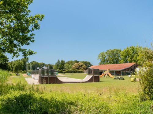 a playground with a slide in a park at Apartment Jade et Elena-4 by Interhome in Lit-et-Mixe