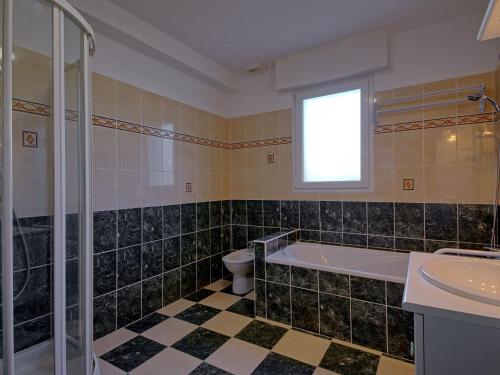 a bathroom with a tub and a toilet and a sink at Holiday Home Villa au Parc Ny by Interhome in Pénestin