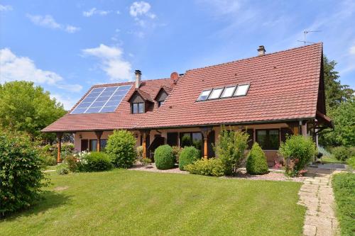 a house with a roof with solar panels on it at Chambres d'hotes Coeur de Sundgau in Leymen