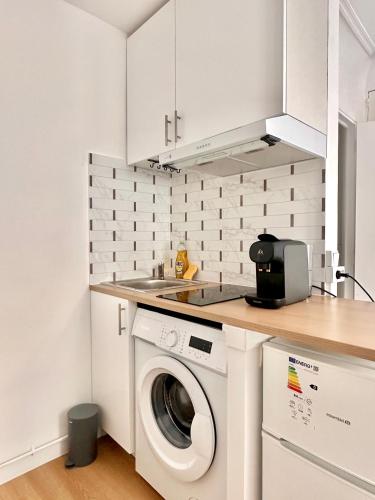 Il comprend une cuisine équipée d'un lave-linge et d'un sèche-linge. dans l'établissement Comfortable studio Notre-Dame de Lorette Rodier, à Paris
