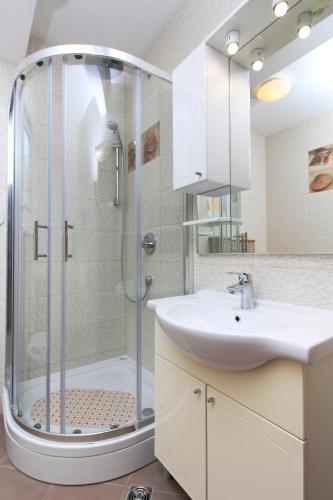a bathroom with a shower and a sink at Apartmani Podest II in Baška Voda