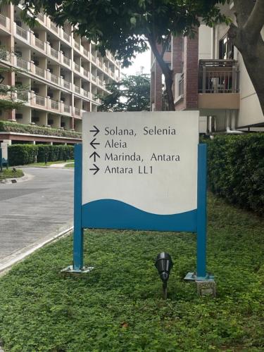 a sign in the grass next to a parking meter at Two Bedroom with Balcony 70sqm -Pasig in Manila