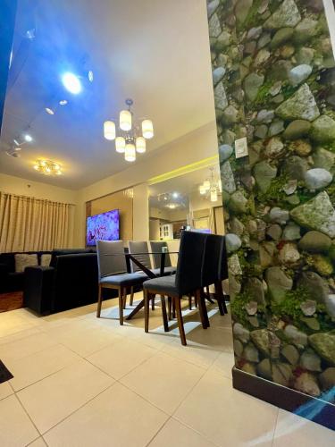 a lobby with a table and chairs and a living room at Two Bedroom with Balcony 70sqm -Pasig in Manila