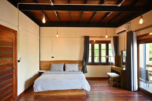 a bedroom with a bed and a desk in it at The Moonlight Guesthouse in Patong Beach