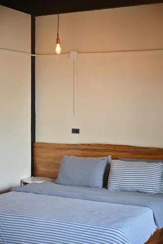 a bedroom with a large bed with a wooden headboard at The Moonlight Guesthouse in Patong Beach
