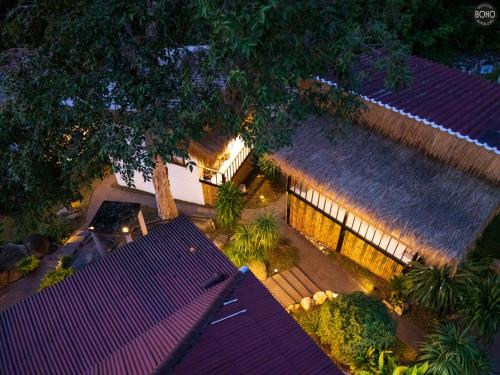 an overhead view of a building with a thatch roof at BOHO Boutique Bungalows in Baan Tai
