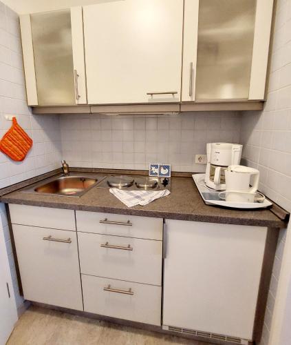 a kitchen with a sink and a counter top at Appartementhaus Berlin in Bad Füssing