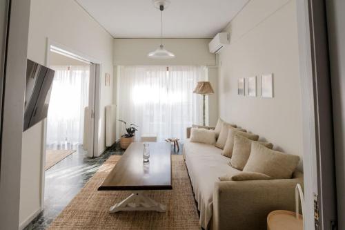 a living room with a couch and a coffee table at Cozy spot in city Center in Patra