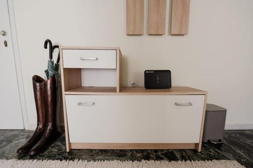 a white dresser with a drawer and boots at Cozy spot in city Center in Patra
