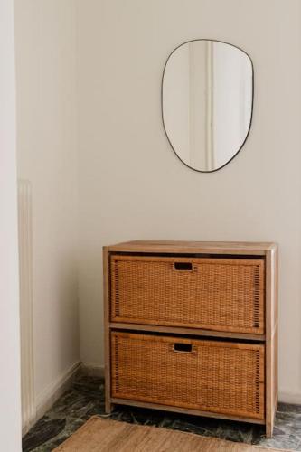 a dresser with a mirror on top of it at Cozy spot in city Center in Patra