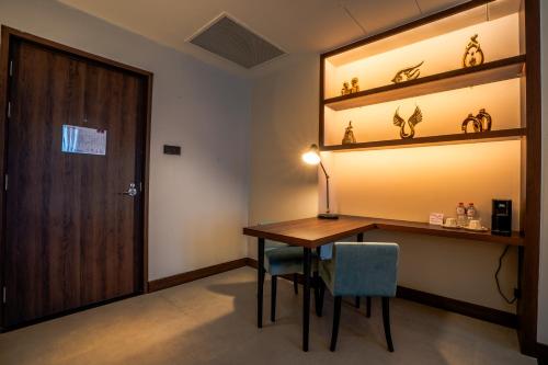 a room with a table and chairs and a door at Sofia Colombo City Hotel in Colombo