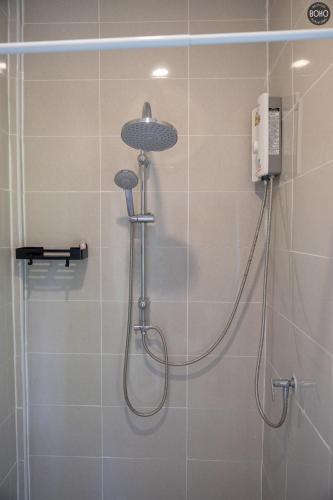 a shower with a shower head in a bathroom at BOHO Boutique Bungalows in Baan Tai