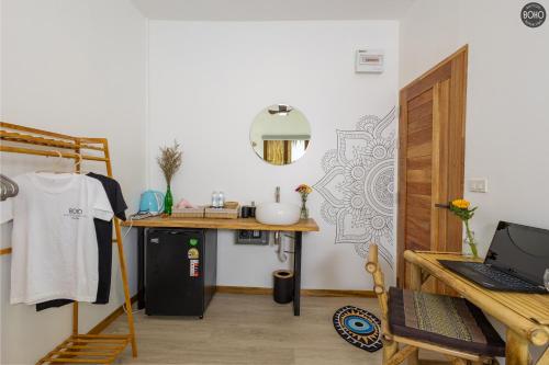 a room with a sink and a desk with a laptop at BOHO Boutique Bungalows in Baan Tai