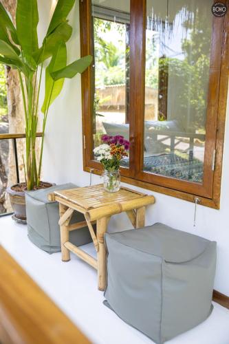 a table and two chairs and a table and a mirror at BOHO Boutique Bungalows in Baan Tai