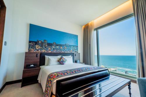 a hotel room with a bed and a large window at Sofia Colombo City Hotel in Colombo