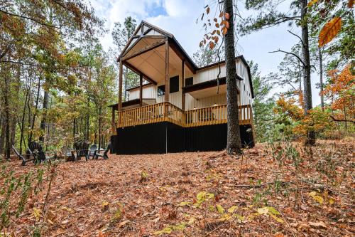 a house in the woods with a tree at 6 Mi to Broken Bow Lake Home with Game Room! in Stephens Gap