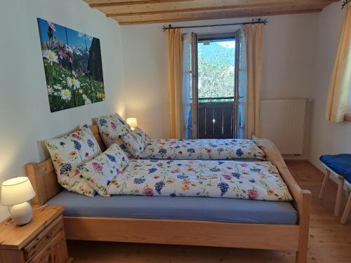 a small bedroom with a bed and a window at Ferienwohnung Schwarzenberger in Lenggries