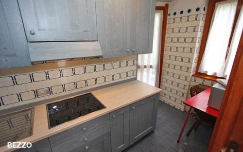 a kitchen with a stove and a counter top at Champoluc Apartment in Champoluc