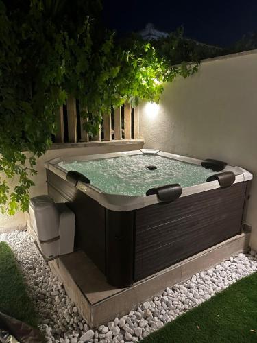 a hot tub in the middle of a yard at night at Luxury Apartment Collection Sea Suite Jacuzzi in Passoscuro