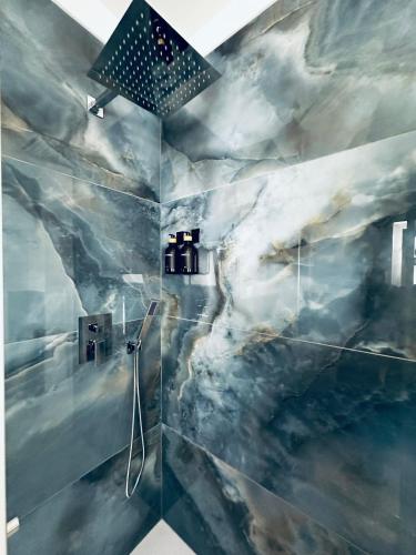 a bathroom with a mountain mural on the wall at Luxury Apartment Collection Sea Suite Jacuzzi in Passoscuro