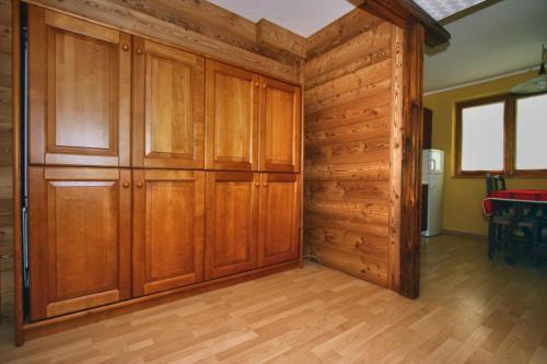 a large room with wooden cabinets in a house at Champoluc Apartment in Champoluc