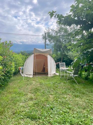 a tent and a chair in a field at Agricampeggio Paolino in Pietramurata