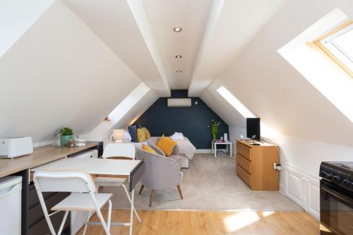 a kitchen and living room with a attic at Stunning studio flat with dedicated private garden in Shrewsbury