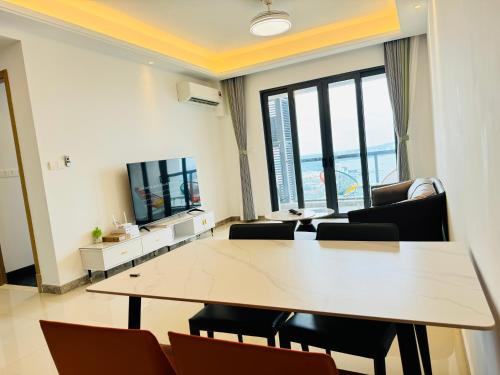 a conference room with a table and chairs and a television at R&F Princess Cove View Residences by WSD in Johor Bahru
