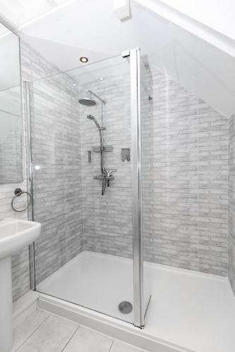 a bathroom with a shower and a sink at The Hayloft, Noss Mayo in Plymouth