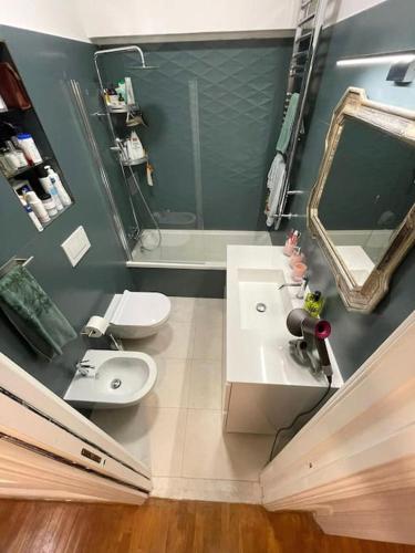 a bathroom with a sink and a toilet and a mirror at Dimora Vantaggio in Rome