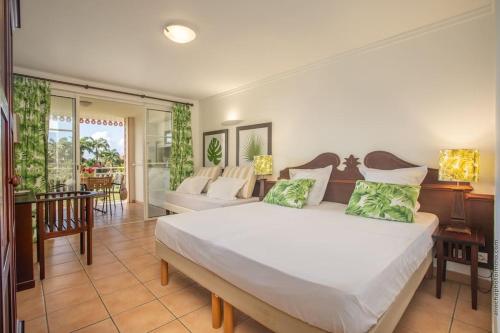 Postel nebo postele na pokoji v ubytování Suite Tropicale Village Vacances
