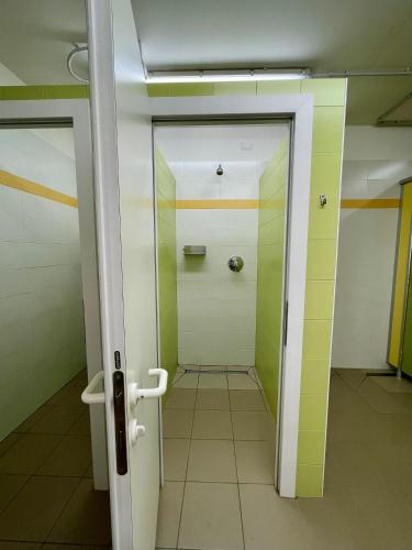 a bathroom with a glass door and a shower at Agricampeggio Paolino in Pietramurata