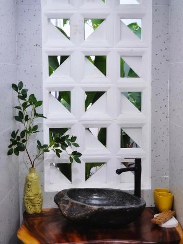 a bathroom with a black sink on a wooden counter at Son house Ninh Chữ cách biển 150m to the beach in Ninh Hải