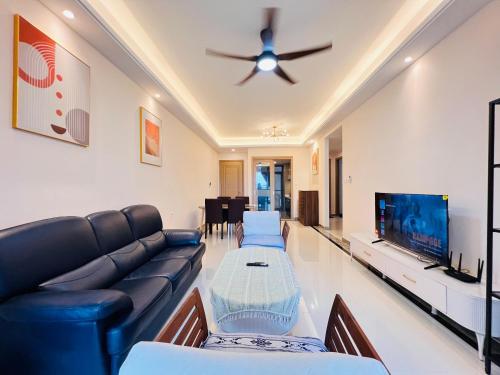 a living room with a couch and a tv at R&F Princess Cove View Residences by WSD in Johor Bahru