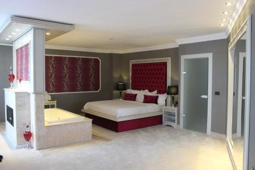 a bedroom with a bed and a bath tub at Phoenicia Grand Hotel in Bucharest