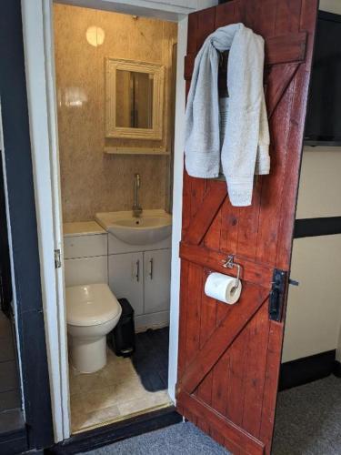 a bathroom with a toilet and a sink at Prestleigh Inn in Shepton Mallet