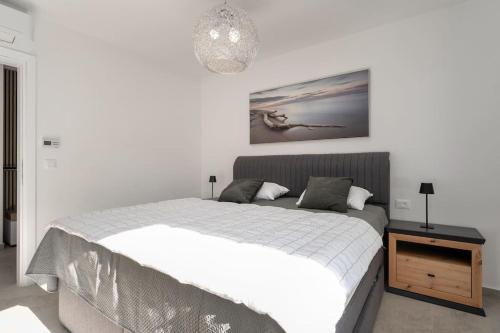 a bedroom with a bed and a picture on the wall at Eleven in Nova Vas