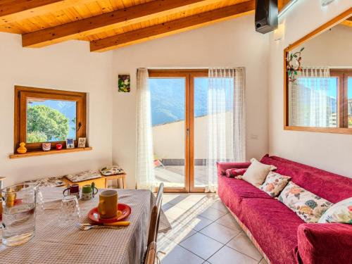a living room with a red couch and a table at Holiday Home Marino by Interhome in Cima