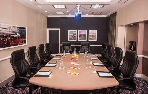 a conference room with a long table and chairs at Garden Court Marine Parade in Durban