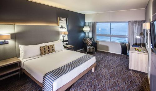 a hotel room with a bed and a large window at Garden Court Marine Parade in Durban